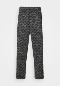 Svarta sweatpants med ett subtilt mörkgrått bladmönster, elastisk midja, lös passform och sidofickor vid anklarna för ökad komfort.