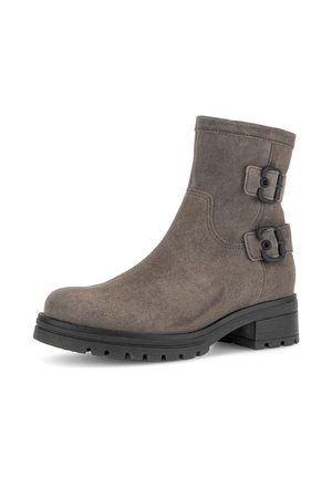 Brown suede ankle boot with two black buckle accents, rounded toe, and a textured rubber sole. Features a low block heel and stitched detailing.