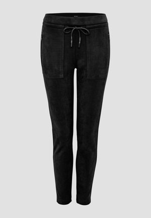 Pantalons de jogging slim-fit noirs en matériau en daim doux, avec une taille élastique, un cordon de serrage et deux poches zippées à l'avant.