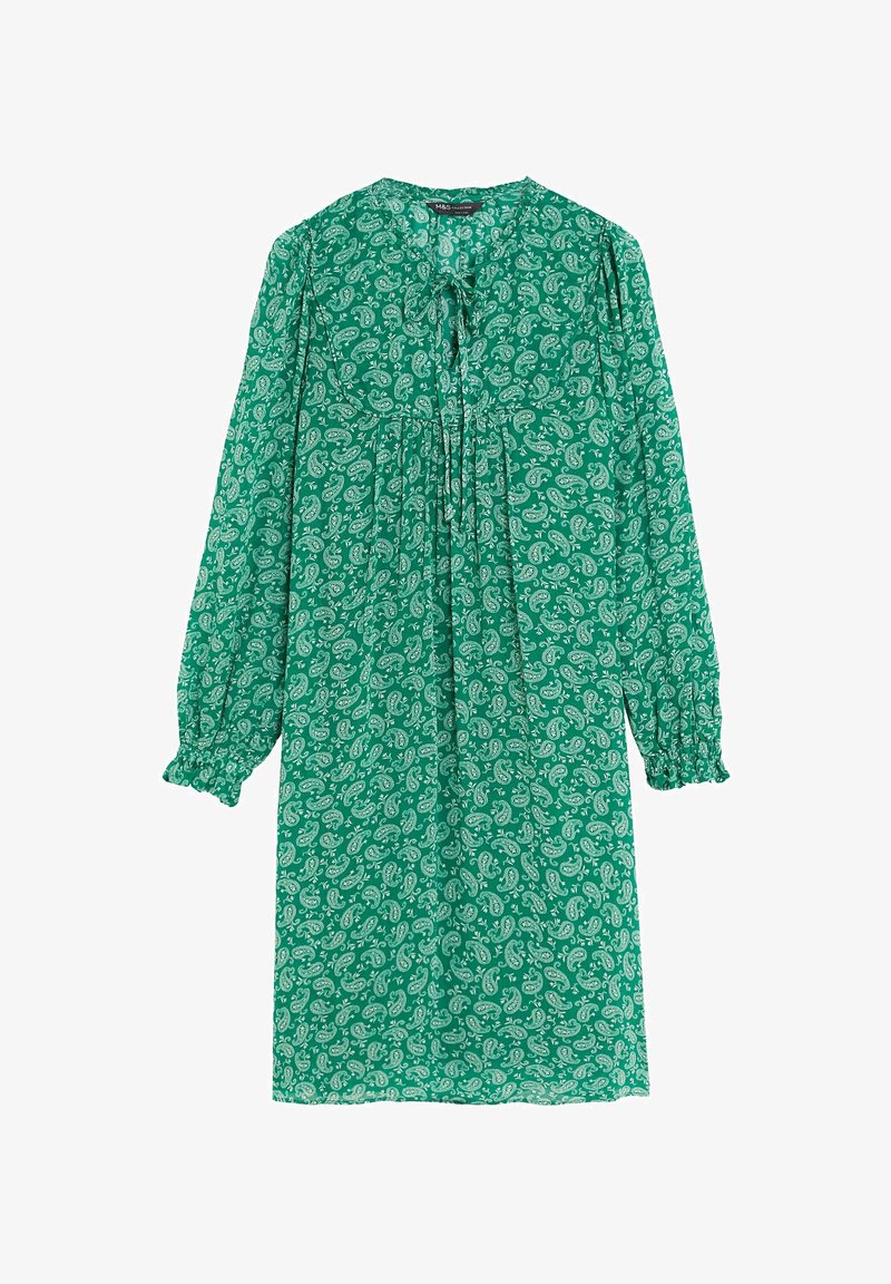 Robe verte à manches longues, longueur genou, avec motif cachemire blanc, poignets froncés et détail noué au niveau du col.
