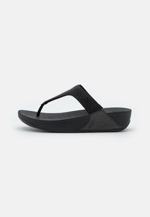 Sorte tanga sandal med en tekstureret rem, polstret sål og en let kilehæl. Designet har en glat finish og holdbare materialer.