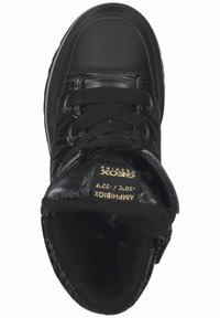 Baskets montantes noires avec un extérieur en cuir brillant, fermeture à lacets, doublure douce et col rembourré avec une étiquette de marque à l'intérieur.