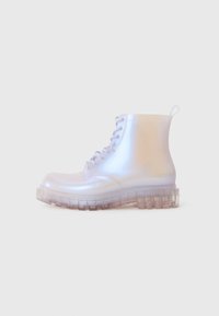 Transparent ankle boots with a glossy finish, featuring a lace-up design and a chunky, translucent sole with treaded pattern.