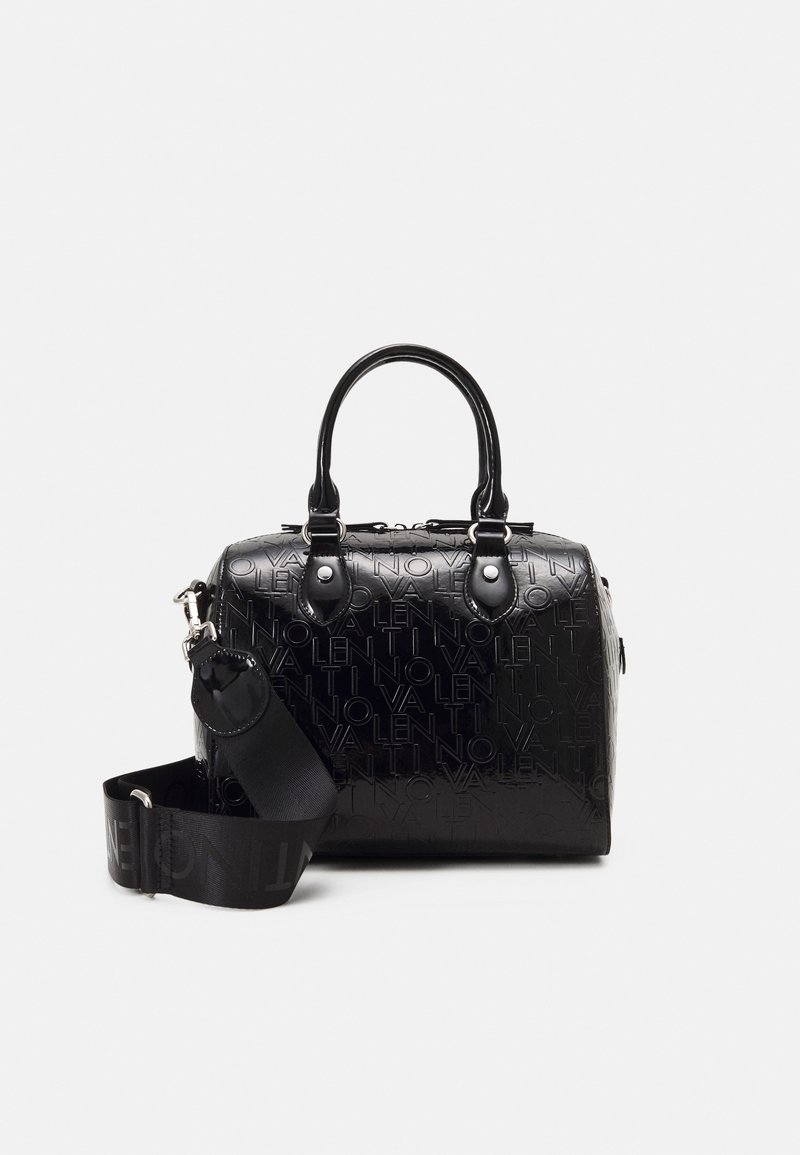 Black embossed handbag with short handles, detachable shoulder strap, featuring a logo pattern and shiny finish. Rectangular shape.