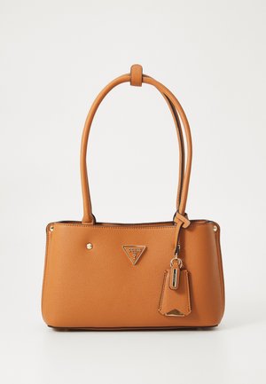 Sac à main GUESS en cuir marron avec doubles poignées, logo triangulaire et étiquette décorative suspendue sur le côté sur fond blanc.