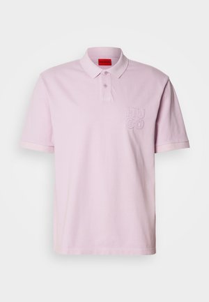 Light pink polo shirt with a collar, short sleeves, and embroidered "HUGO" logo on the left chest. Made of soft fabric, smooth texture.