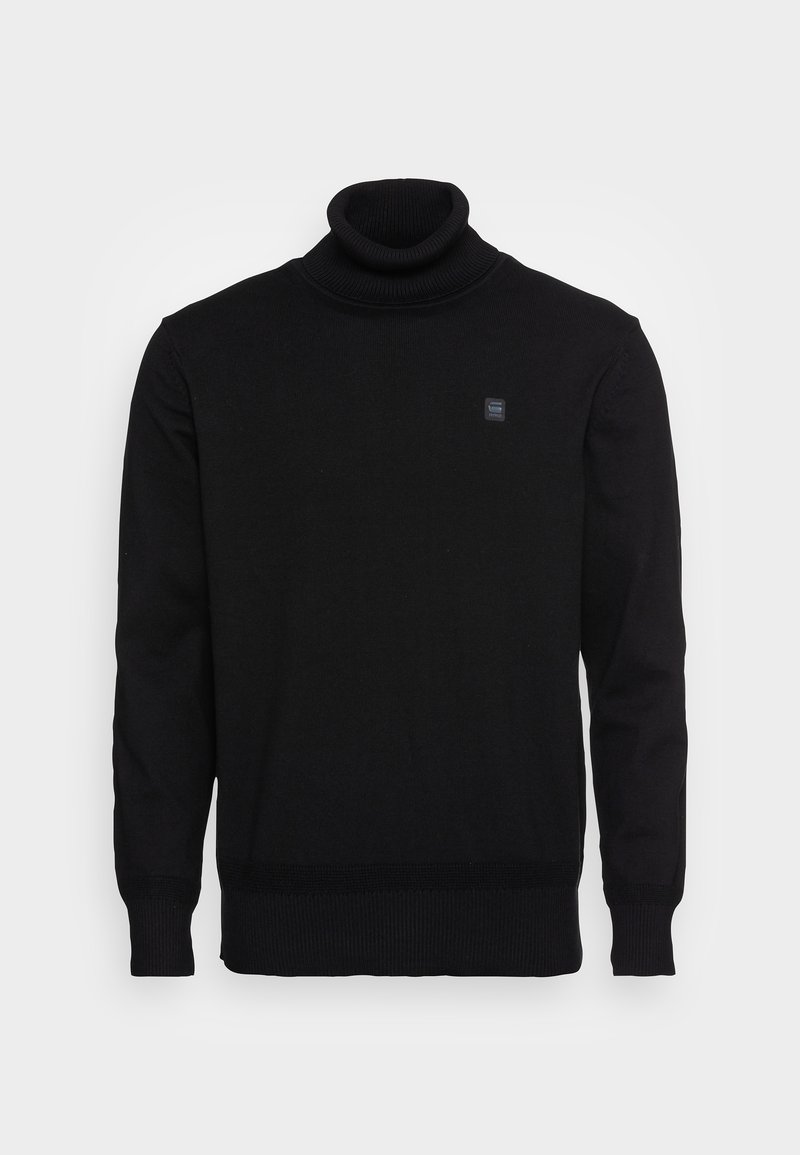 Pull en col roulé noir avec des poignets côtelés, une coupe ajustée et un petit logo carré sur la poitrine. Fabriqué en tissu tricoté doux.