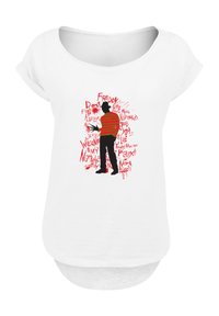 White short-sleeve top featuring a graphic of a character in red and black stripes, with text elements in various fonts and red accents.