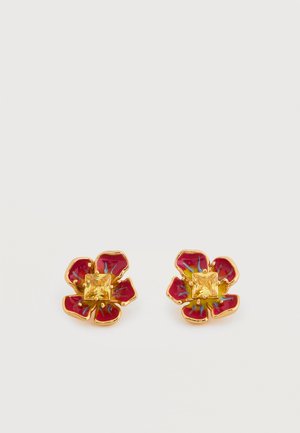 Pair of gold-tone flower stud earrings with red enamel petals and a yellow square gemstone center on a white background.