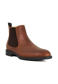 Brown leather ankle boot with elastic side panels, rounded toe, and a textured black rubber sole. Features a pull tab for easy wear.