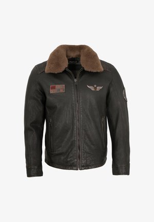 Dark brown leather bomber jacket with a plush shearling collar, front zipper, zip pockets, and aviation-themed embroidered patches.