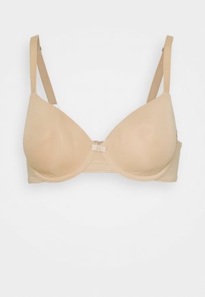 Beige gevoerde beugelbh met verstelbare bandjes en een kleine decoratieve strik aan de voorkant in het midden.