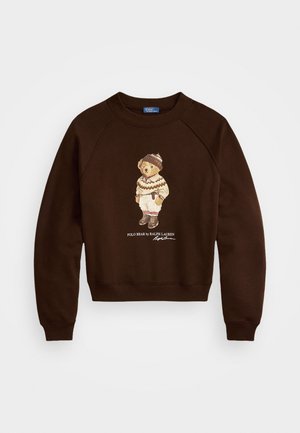 Barna kapucnis felső, kerek nyakkal és raglán ujjal, mely egy téli öltözetbe öltöztetett medve grafikáját és a "POLO BEAR by RALPH LAUREN" feliratot tartalmazza.