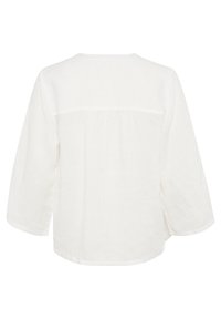 Blouse en lin blanche à manches longues, à coupe ample, avec un empiècement au dos froncé et un col rond, vue de dos.