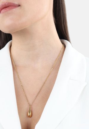 Collana d'oro con un pendente a goccia su una delicata catenina. Il pendente ha una finitura lucida, conferendo un aspetto elegante e moderno.