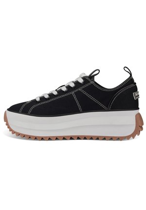 Black canvas sneakers with white laces, thick white midsole, and textured brown outsole featuring zigzag pattern. Subtle side logo detail.