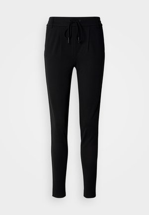 Schwarze Jogginghosen aus weichem, dehnbarem Stoff; mit Kordelzugbund, Falten und zulaufenden Beinen für eine figurbetonte Passform.