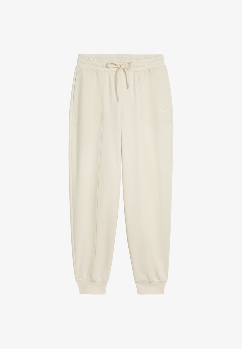 Krēmkrāsas sporta bikses ar elastīgu jostu un aukliņu, kurām ir divas sānu kabatas un ribotas aproces pie potītēm.