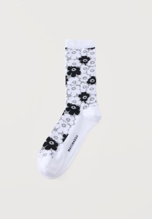 Λευκή κάλτσα με μαύρο και γκρι floral μοτίβο και κείμενο "Marimekko" στη σόλα, εμφανίζεται σε απλό ανοιχτό φόντο.