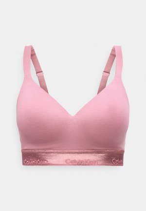 Bezšuvju rozā polsterēts krūšturis ar regulējamām lencēm un metālisku joslu ar Calvin Klein logotipu ap apakšmalu.