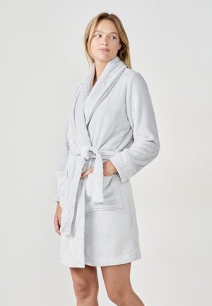 Accappatoio in pile grigio chiaro con colletto a scialle, cintura e due tasche frontali. Tessuto morbido, design fino al ginocchio e polsini a coste.