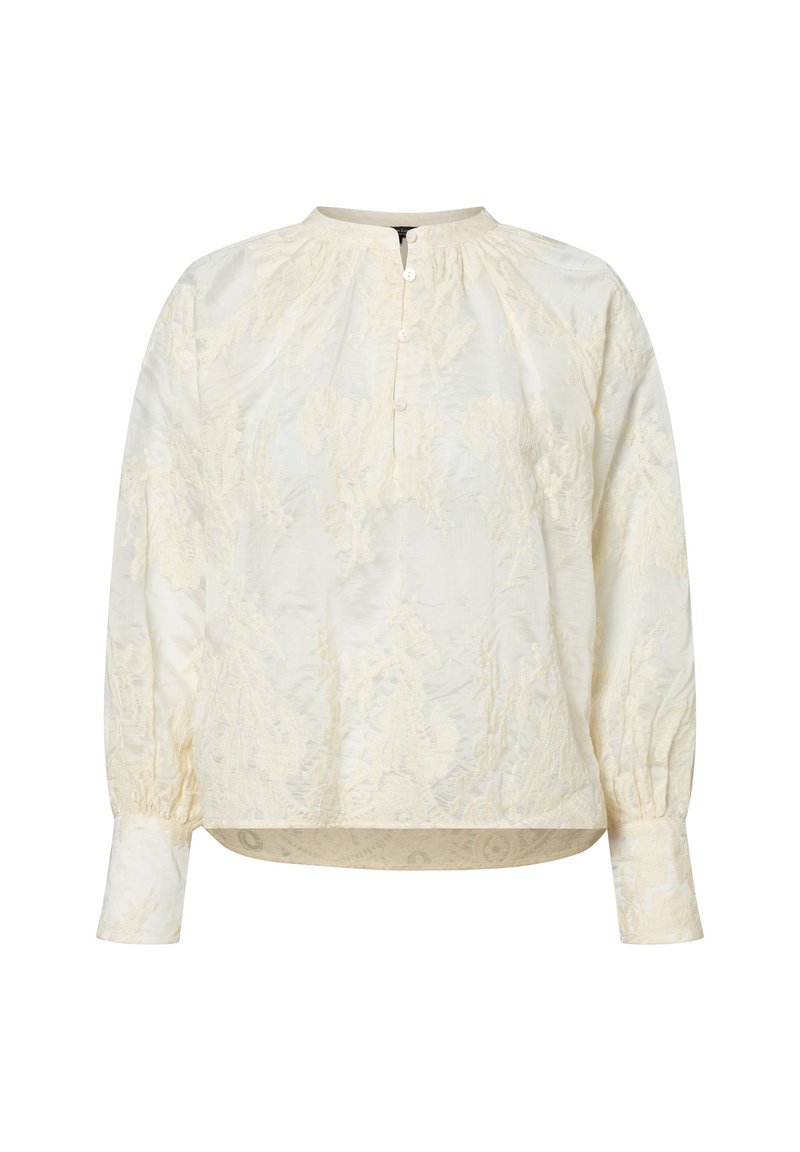 Blusa crema con ricami floreali, collo rotondo, patta con bottoni e maniche lunghe con polsini elastici. Texture morbida e vestibilità ampia.