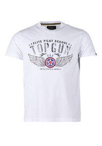 Valkoinen T-paita, jossa on teksti "Elite Pilot School TOP GUN", Yhdysvaltain laivaston rondelli siipineen, kaksi lentokonesilhuettia ja teksti "Yhdysvallat" alapuolella.