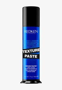 Redken Texture Paste in een blauwe cilindervormige container met een zwarte bovenkant en label. Bevat vetgedrukte zwarte tekst en een glanzende afwerking. 75ml formaat.