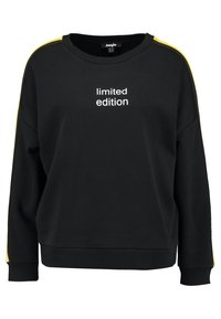 Sweat-shirt noir à col rond, avec des bandes latérales jaunes et le texte « édition limitée » en blanc sur le devant. Tissu doux et texturé.