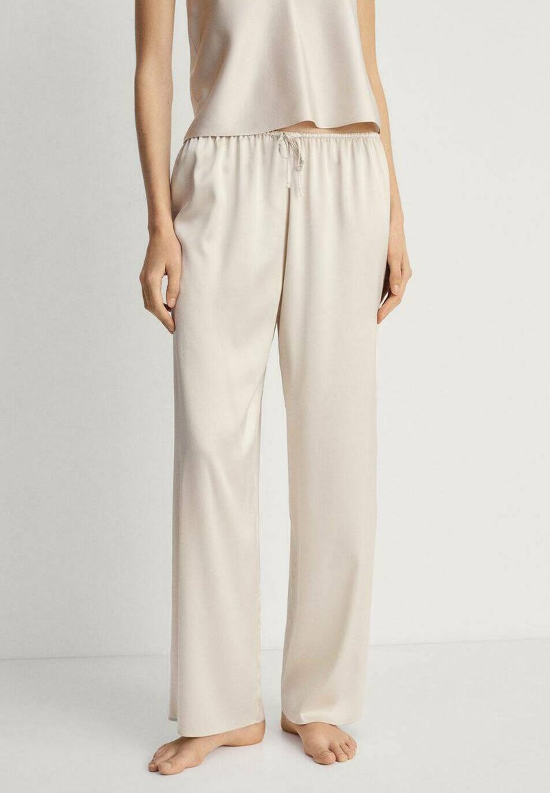 Bež, lagane hlače opuštenog kroja s elastičnim pojasom i vezicom. Glatka tekstura, punog kroja, pogodne za svakodnevno nošenje.