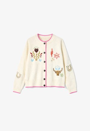Κρεμ ζακέτα με μαύρα κουμπιά, ροζ περιθώριο και πολύχρωμα κεντημένα μοτίβα, όπως κάκτος, κλειδί, πεταλάδες, αστέρι και κρανίο ταύρου.