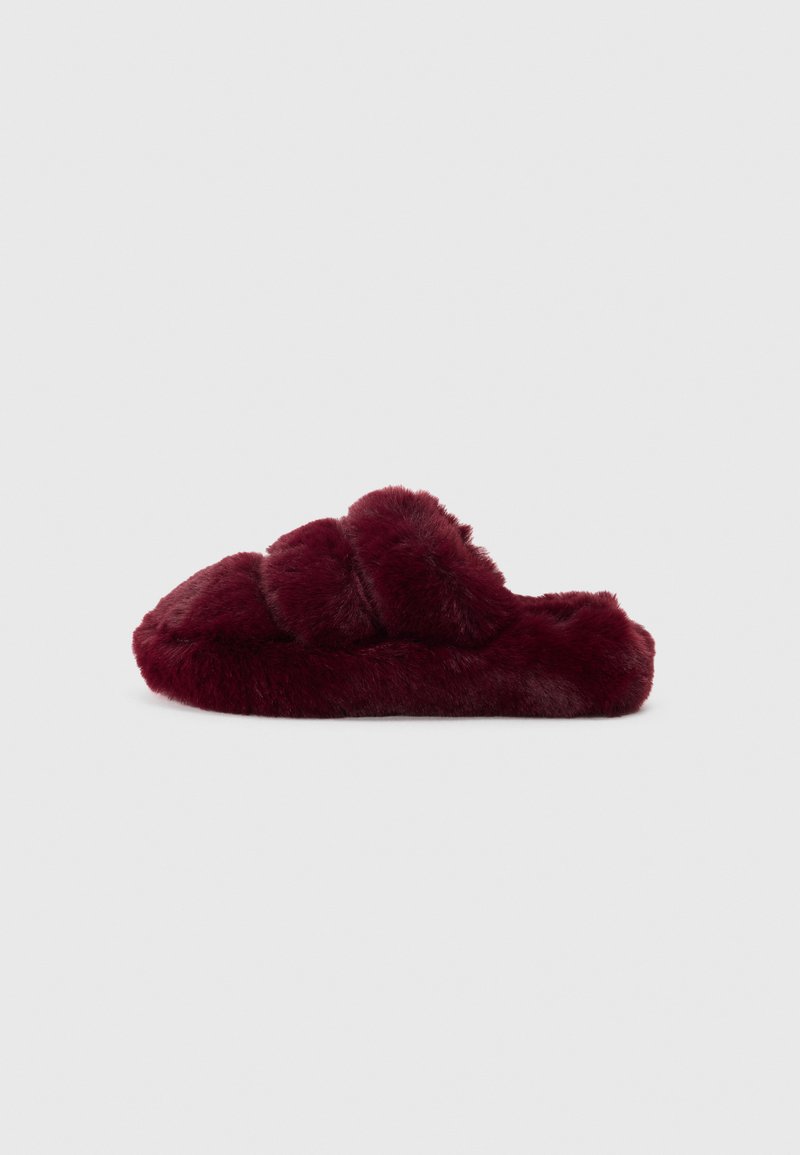 Chinelo de pelúcia burgundy com biqueira arredondada, superfície texturizada e design superior trançado. Aparência macia e luxuosa, sem acessórios visíveis.