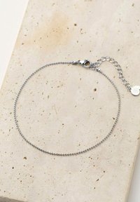 Silver chain bracelet featuring small rounded beads, a lobster clasp, and an adjustable chain with a circular accent charm.