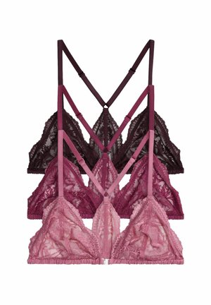 Three lace bralettes in pink, burgundy, and dark brown, stacked with thin adjustable straps and no underwire, on a white background.