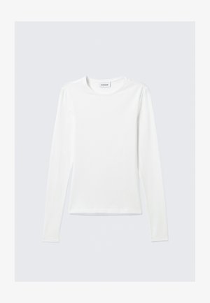 T-shirt de manga longa branca com um rótulo "WEEKDAY" no colarinho interior, disposto em plano sobre um fundo cinza claro.