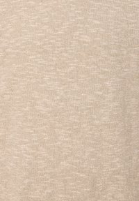 Tessuto a maglia beige con una superficie morbida e testurizzata; presenta un aspetto leggero e melangiato con sottili variazioni di tonalità.