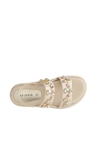 Beige sandal with two wide straps, embellished with colorful gems in various shapes, on a cushioned footbed. "AFENOIR" branding visible inside.