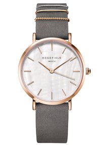 Orologio Rosefield con cassa in acciaio inox rose gold, quadrante in madreperla bianca, cinturino in pelle grigia sottile e semplici dettagli dorati.