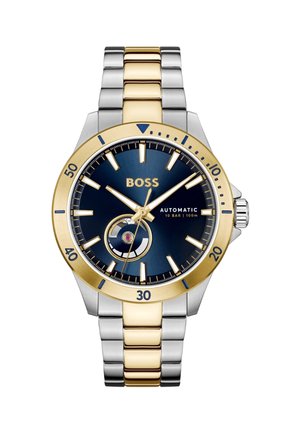 Automatisch horloge heeft een blauwe wijzerplaat met zilveren en gouden accenten, een bicolor metalen armband en een ronde wijzerplaat met markeringsdetails.