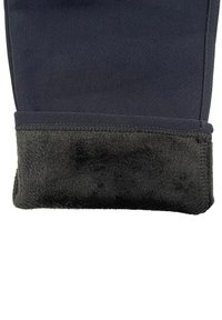 Black leg warmers with a smooth outer fabric and a soft, fuzzy inner lining, featuring a stitched edge for durability.