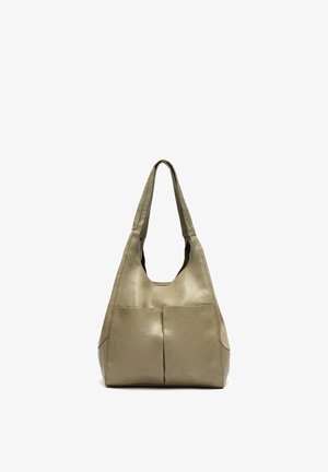 Miękka beżowa skórzana torba na ramię z szerokimi uchwytami i dwoma przednimi kieszeniami, stojąca pionowo na białym tle.