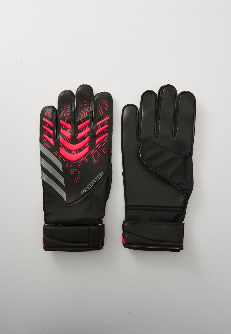 Black goalkeeper gloves with textured grip in pink and gray accents, featuring adjustable wrist straps and a padded palm for protection.