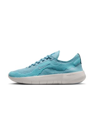 Light blue athletic shoe with a textured mesh upper, flat white sole, and rounded toe. Features sleek design and minimal branding.