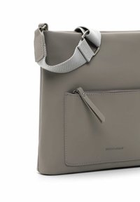 Gray leather crossbody bag with a textured fabric strap, zippered front pocket, and subtle embossed branding on the side.