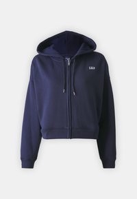 Sudadera cortada de cremallera en azul marino, hecha de una suave mezcla de algodón. Cuenta con una capucha, cordones y un pequeño logo blanco en el lado izquierdo del pecho.