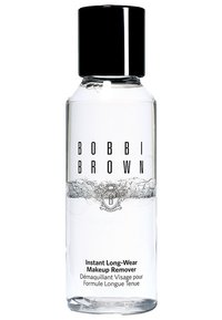 Klarer flüssiger Make-up-Entferner in einer zylindrischen Flasche mit schwarzem Deckel. Auf dem Etikett sind schwarze Schriftzüge und ein dekoratives silbernes Logo zu sehen.