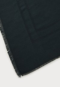 Black scarf made of soft fabric with a fringed edge, featuring a subtle rectangular pattern in a slightly darker hue.