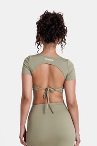 Olijfgroene geribbelde top met korte mouwen en een open rug. Voorzien van een strikdetail op de taille en een merkembleem op de halslijn.