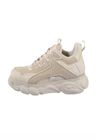 Beige sneaker with a mix of smooth leather and textured panels, featuring a cushioned sole, laces, and a branding detail on the side.