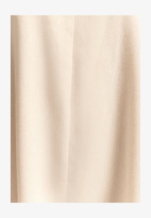 Tissu beige à surface texturée ; motif tissé ; semble doux et léger ; présente des variations subtiles de ton de couleur.